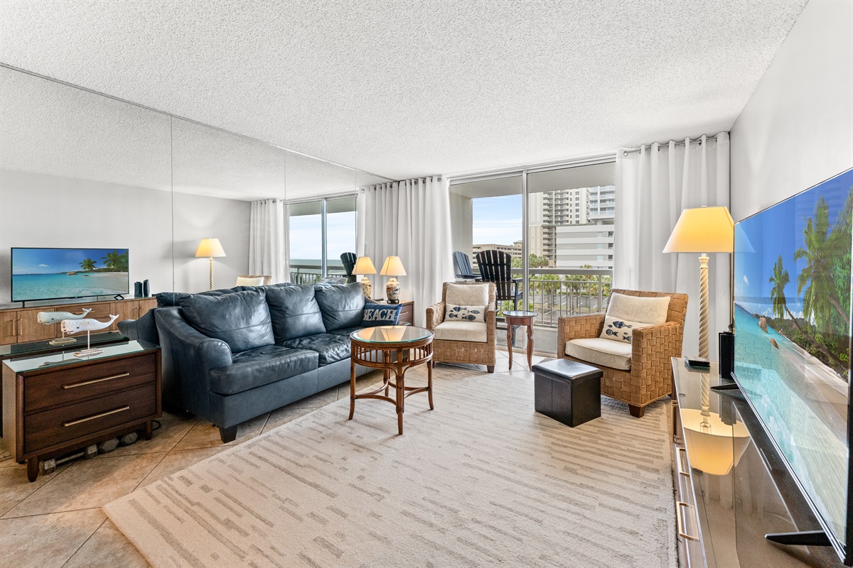Spacious Living Room  with large TV and balcony access