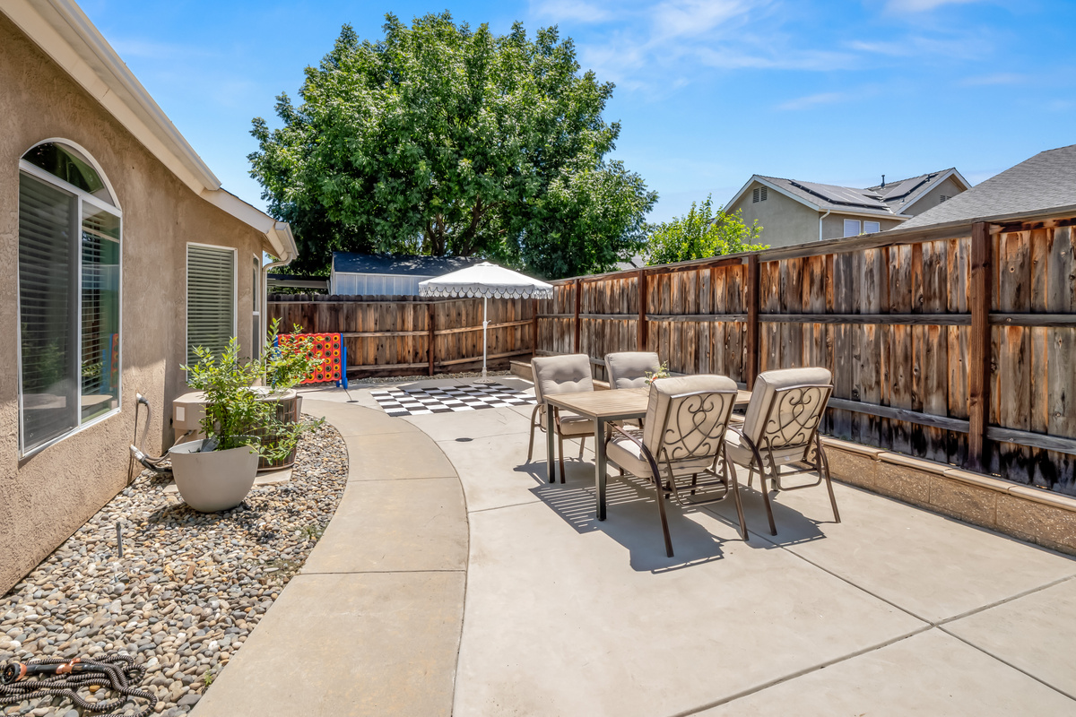 This private backyard is designed for fun and relaxation, featuring oversized yard games, outdoor seating, and plenty of space to enjoy the California sunshine with family and friends.