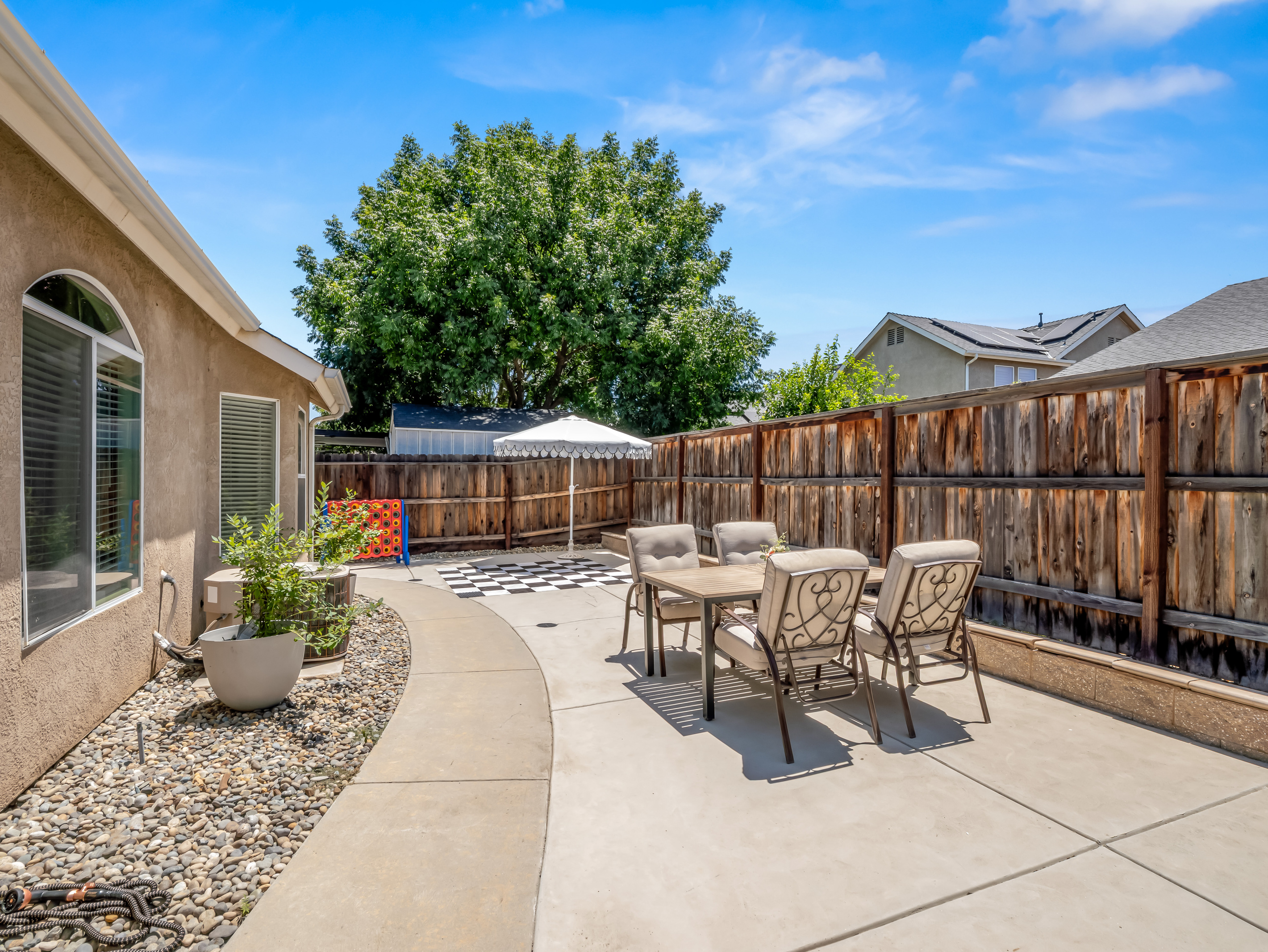 This private backyard is designed for fun and relaxation, featuring oversized yard games, outdoor seating, and plenty of space to enjoy the California sunshine with family and friends.