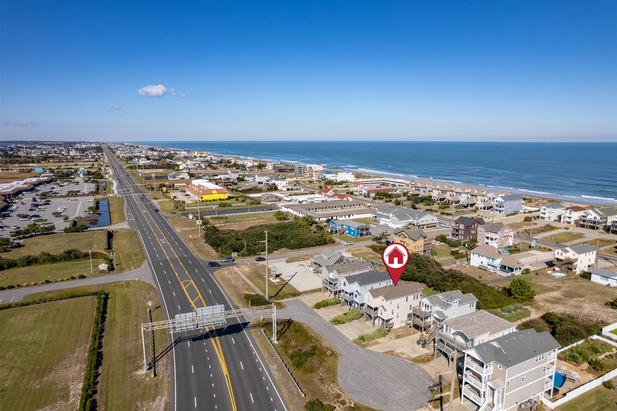 Aerial angle showing the home centered within the residential area, with the highway, beach, and local amenities all easily accessible.