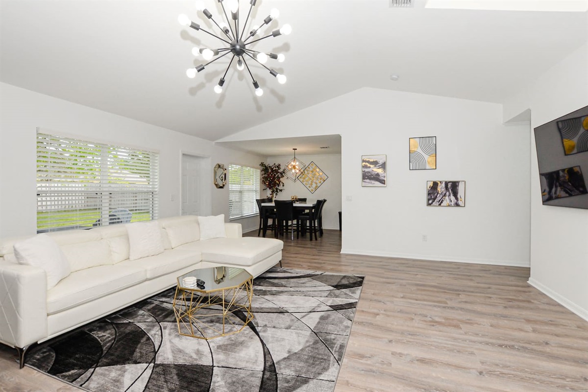 Spacious living room with a cozy couch positioned perfectly in front of the TV for ultimate relaxation.