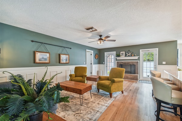 A second living room off the open kitchen features a decorative fireplace.