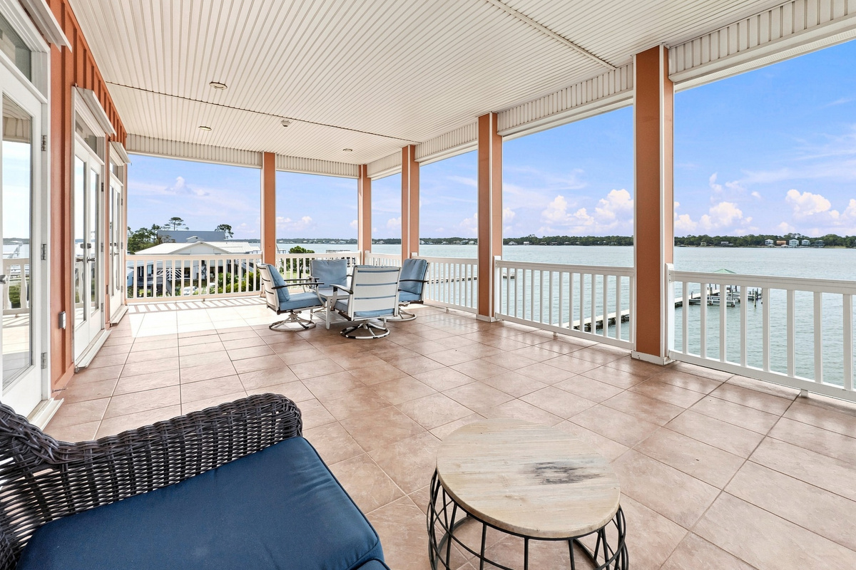 Expansive covered balcony with panoramic lagoon water views