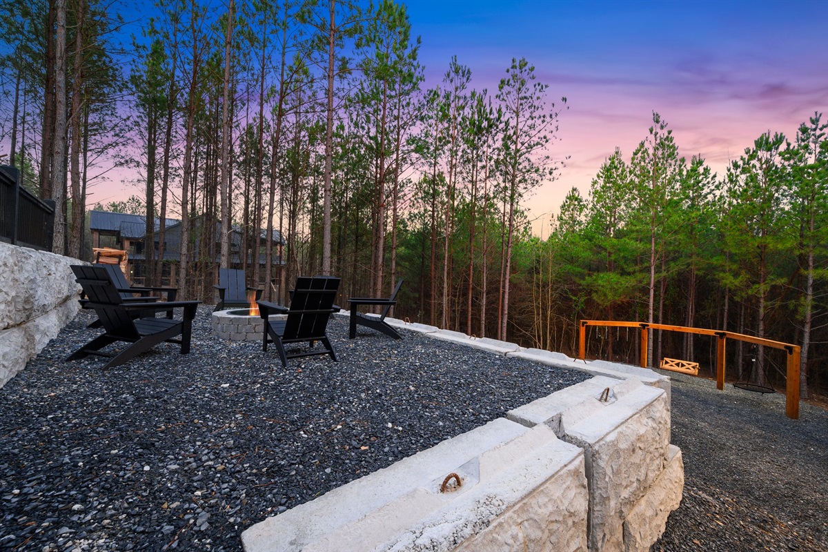 Gather around the firepit under the evening sky and enjoy cozy nights surrounded by the woods.