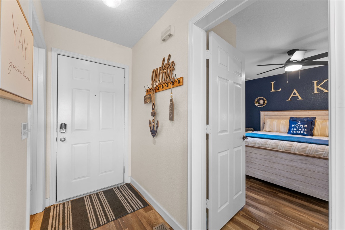 Welcoming entry with warm wood floors and lake-inspired décor.