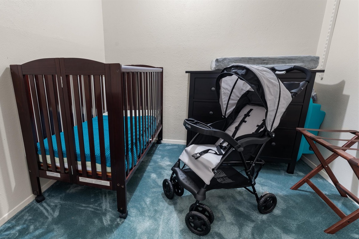 King Bedroom 2 is perfect for guests traveling with little ones! It includes a dedicated baby-friendly space with a crib, changing station, stroller, and a Pack 'n Play.