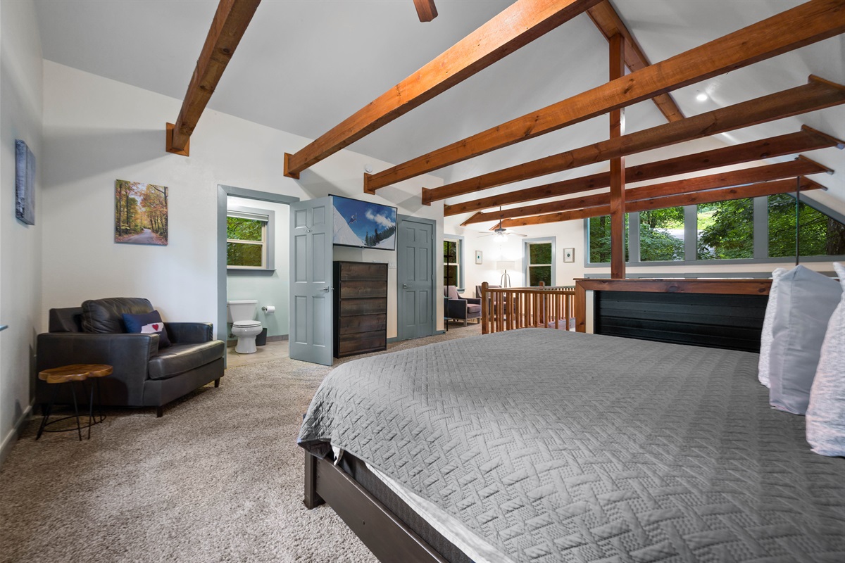 The upstairs loft has a reading nook, king bed, and bathroom!