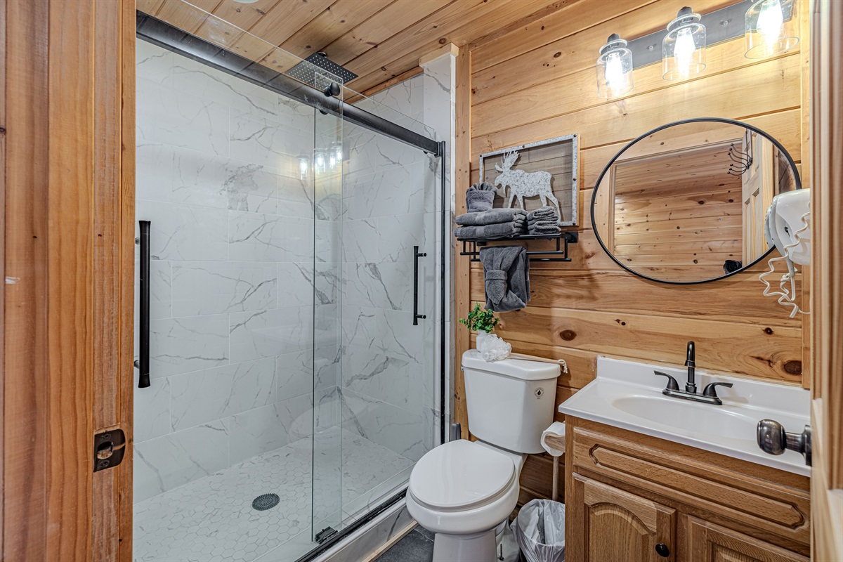 Recently renovated full bathroom with a rainfall shower head for the ultimate comfort