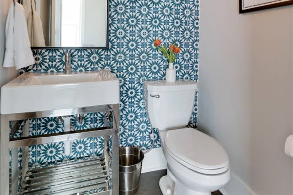 - Dazzling patterned tile wall creates a vibrant and playful statement - Chrome vanity with open storage and vessel sink adds a modern touch - Fresh flowers and bright light bring cheer to this charming half bath