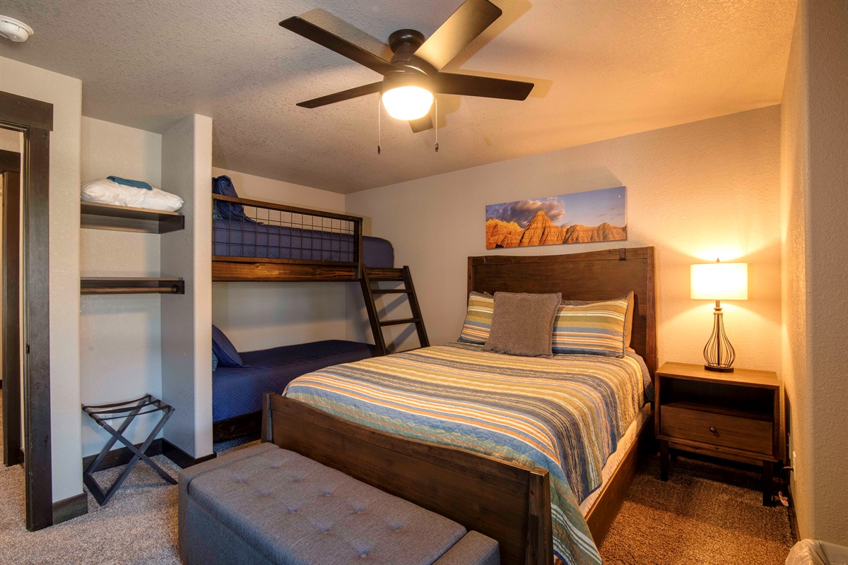 Perfect for families or groups, this lower-level bedroom features a cozy queen bed and 2 sets of twin bunks—plenty of space for kids, teens, or extra guests to rest and recharge.