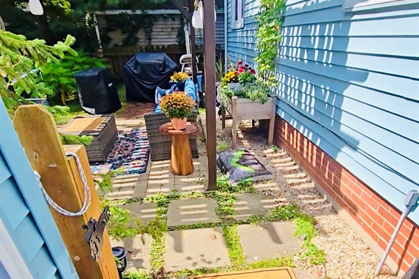 Step through the open gate and into backyard bliss—where the pergola invites lingering, herbs grow within reach, and the grill’s ready for your next gathering. Welcome mat’s out, and so are good vibes.
