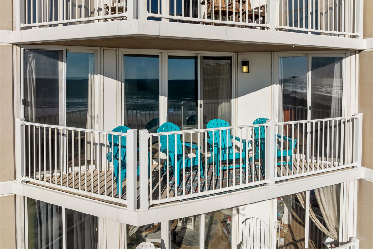 Exterior view highlighting the unit&rsquo;s spacious balcony with ocean just beyond the railing