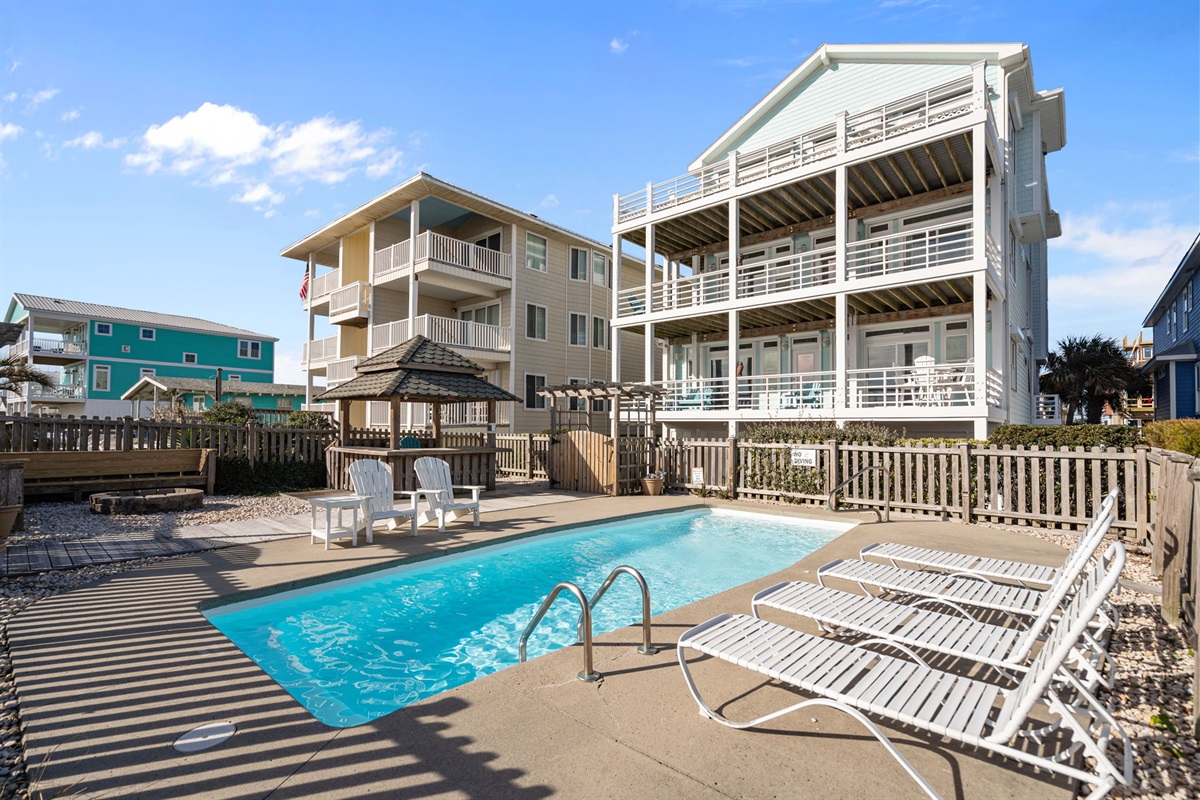 Pool deck with firepit, tiki bar, saltwater pool and plenty of space for fun