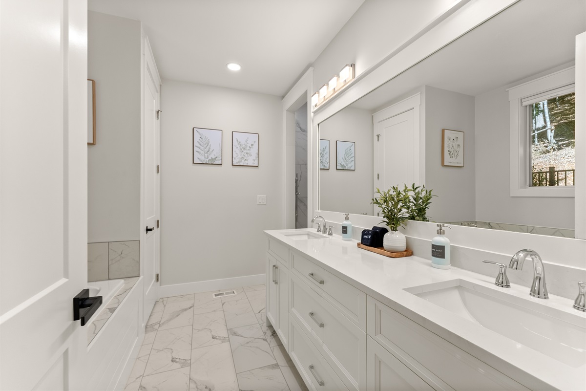 Primary suite bath with double vanity.
