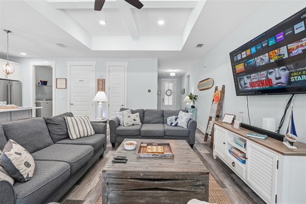 Game night with family and friends is a blast with comfy couches and blankets in the main open living with a large selection of games, a stereo and a large TV for movie night.