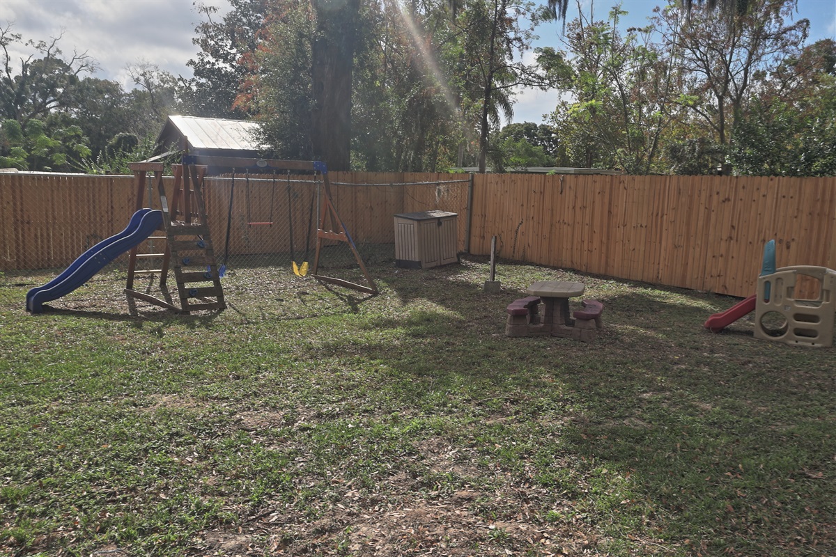 childrens play area in fenced yard