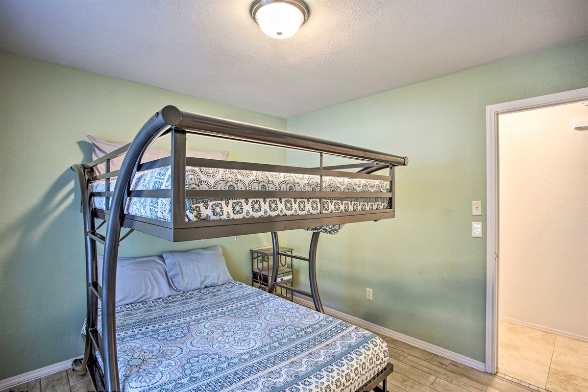 Green bedroom with full over full bunk bed