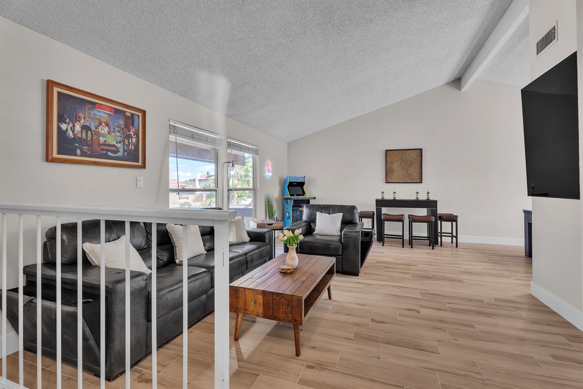 Living room 1 with 86 inch tv, simpsons arcade, bar table that converts to roulette and craps