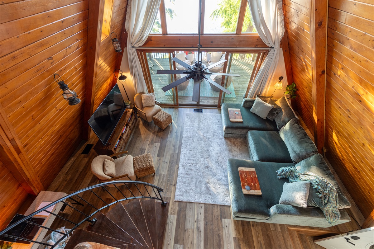 Warm vaulted ceilings, huge comfortable sofa and giant TV all add to the character and calm of The Ridge living room.