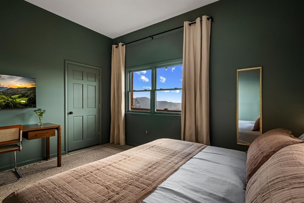 A second view of the king bedroom with a dedicated desk for work or planning the day, plus a large closet for added convenience.