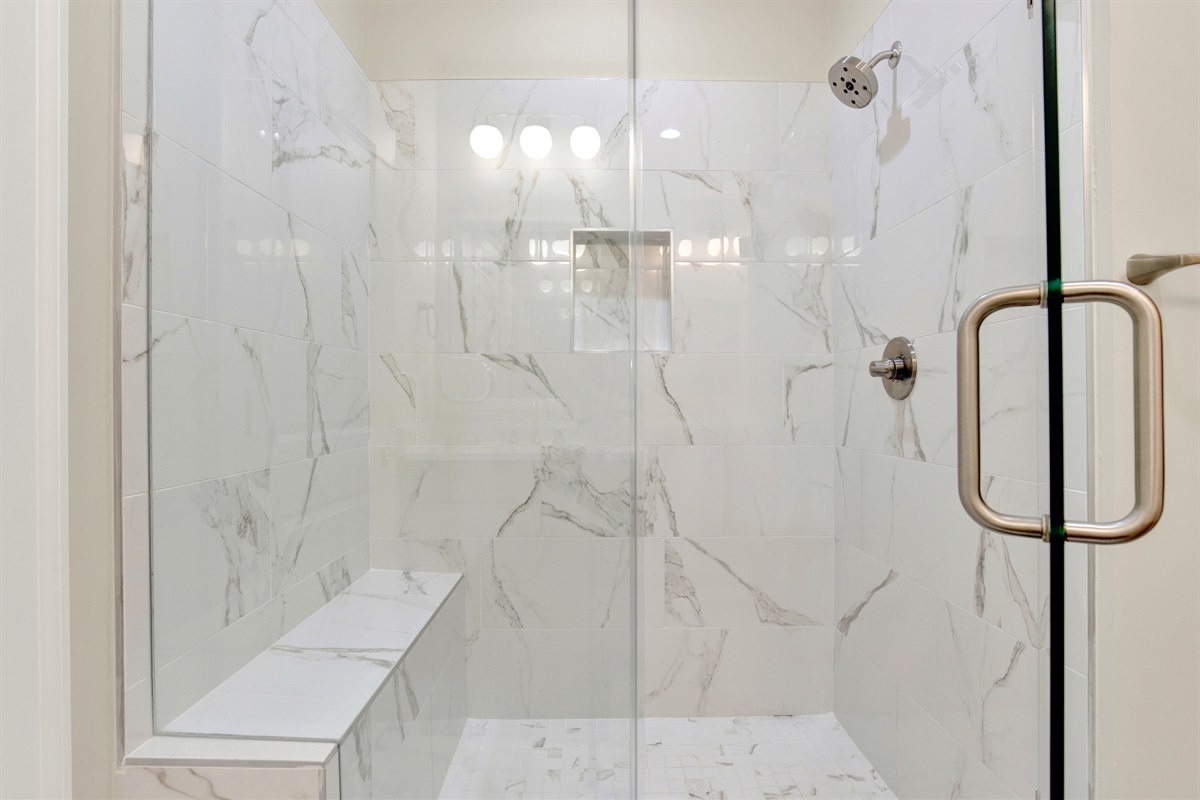 Primary King size ensuite bathroom shower with seat and niche