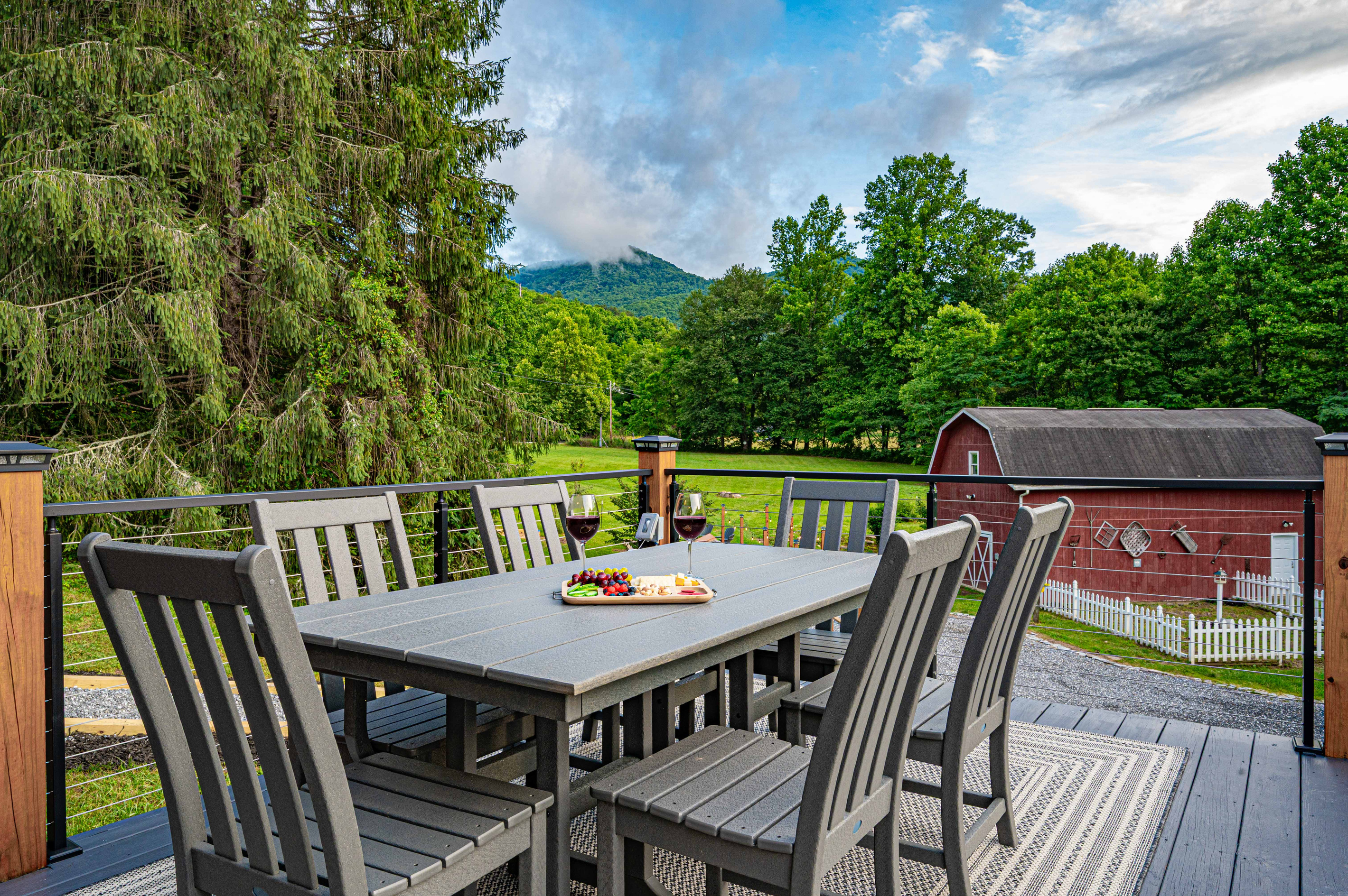 Outdoor Dining Oasis: Savor meals with stunning mountain views and a charming barn backdrop!
