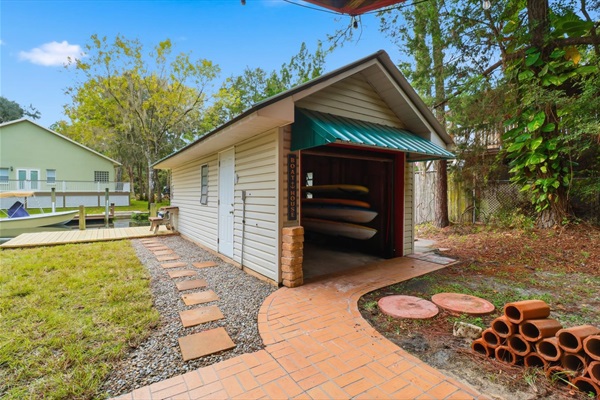 Boathouse full of kayaks, paddle boards, fishing gear and more