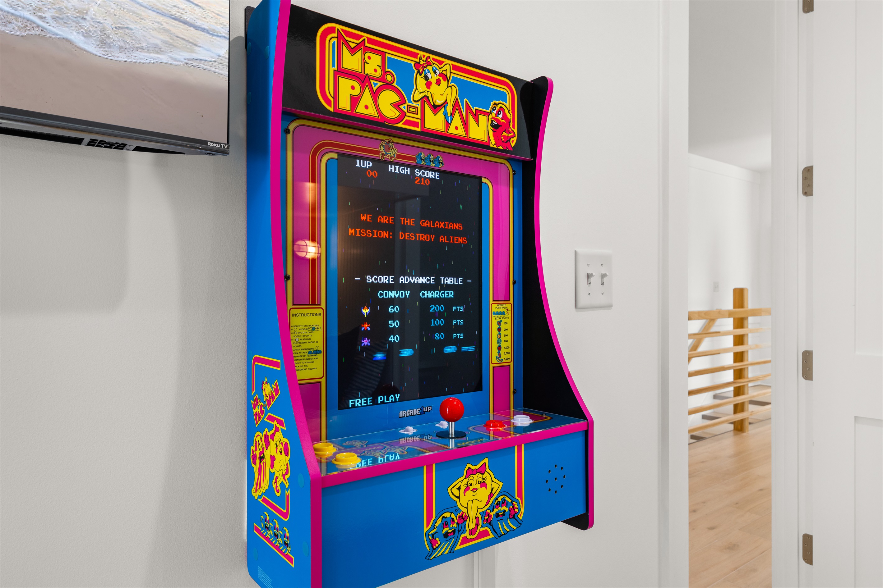 The fun continues indoors with a classic arcade game, creating the perfect entertainment space for kids and adults alike after a day in the sun.