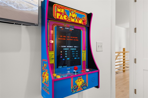 The fun continues indoors with a classic arcade game, creating the perfect entertainment space for kids and adults alike after a day in the sun.