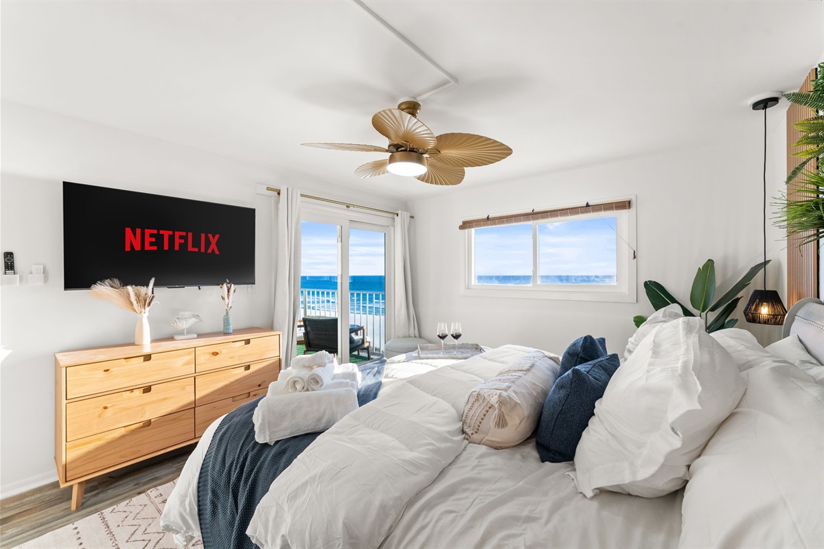 The master suite features both a window and patio doors with a 55 inch smart TV, dresser and closet, access to your own en-suite and plenty of bed side USB-USBC and regular charging points