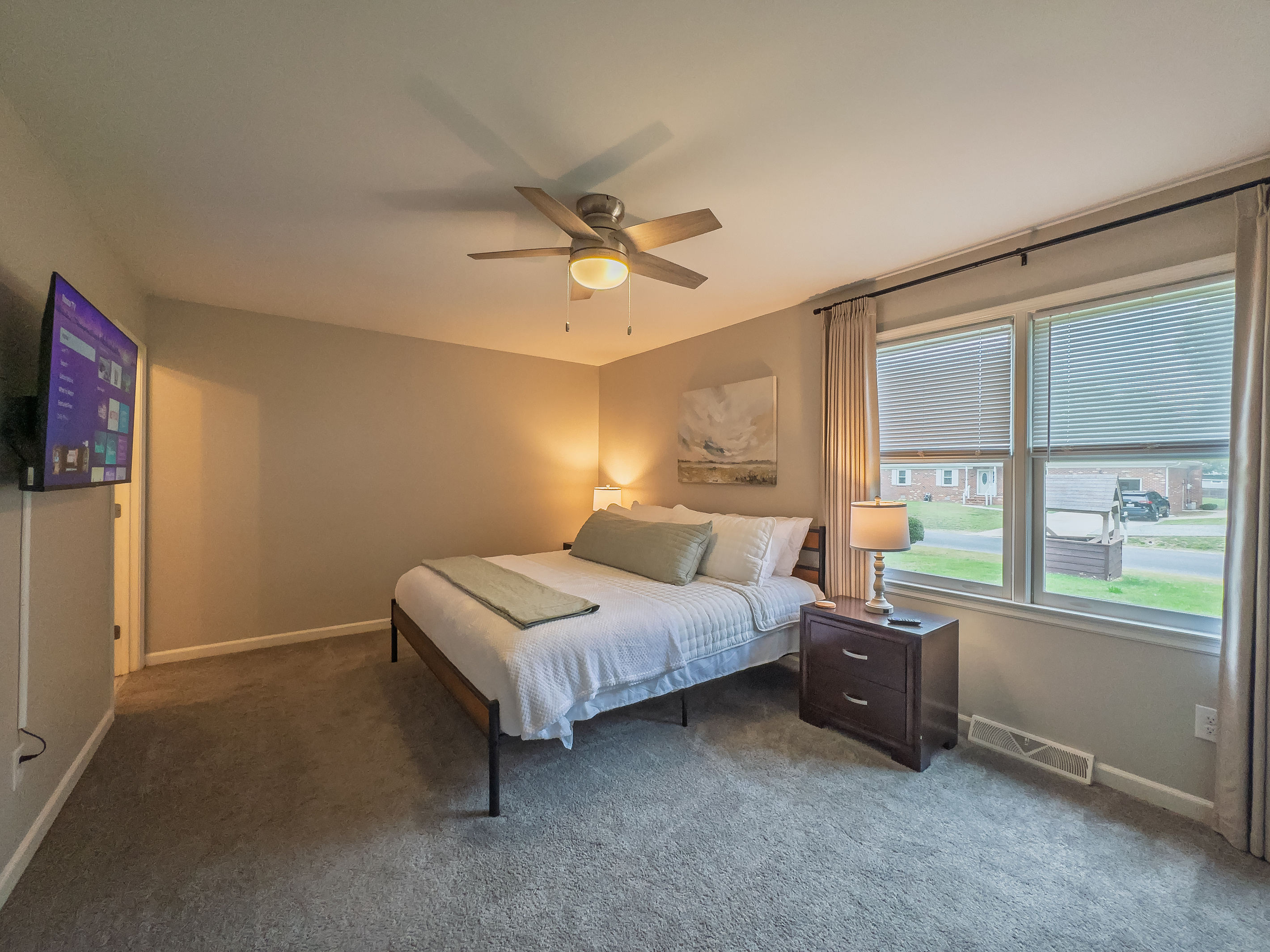 Primary Bedroom, King bed, 55" Smart TV, ceiling fan, two led light nightstands with multiple charging ports, two multi light function lamps, blackout curtains, dresser and closet, private full bathroom.