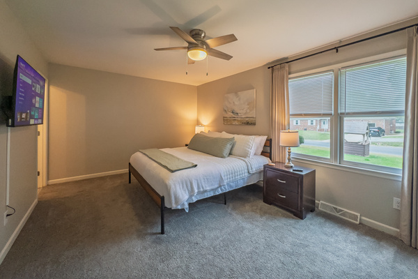 Primary Bedroom, King bed, 55" Smart TV, ceiling fan, two led light nightstands with multiple charging ports, two multi light function lamps, blackout curtains, dresser and closet, private full bathroom.