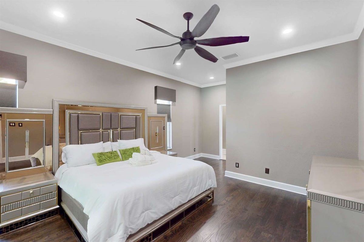 Serene master bedroom w/ soft light & ample space.