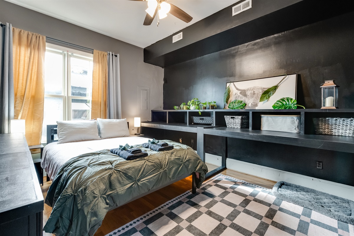 Queen Bedroom 1: Stylish decor, bright natural light, and a touch of nature await you!