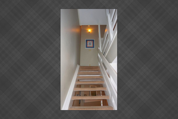 Head upstairs to the bedroom level &mdash; carpeted stairs, easy access, and the separation of floors means the kids' loft and the adult suites each have their own quiet.