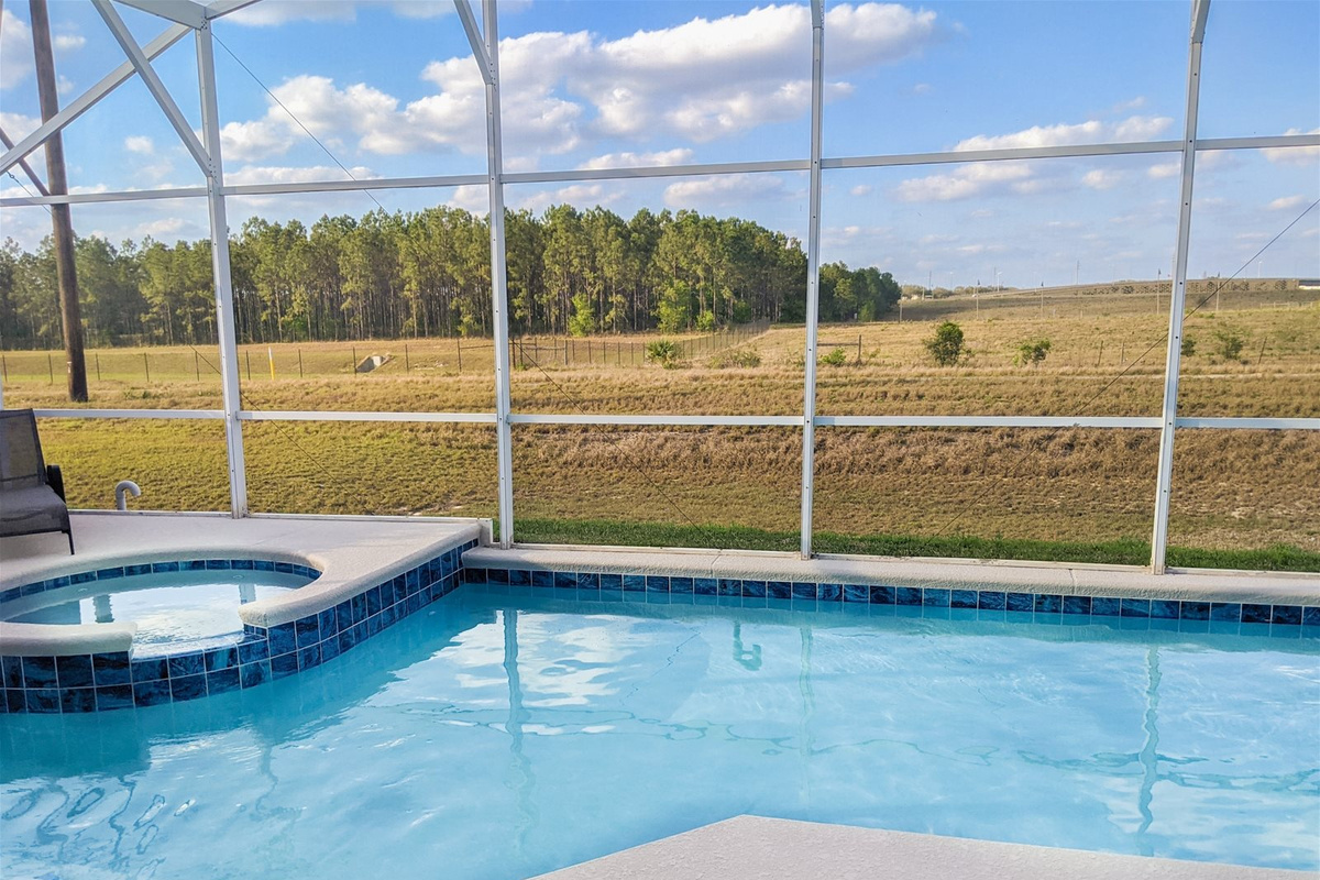 Lush nature right outside your Private Screened Patio Pool with connecting Hot Tub.