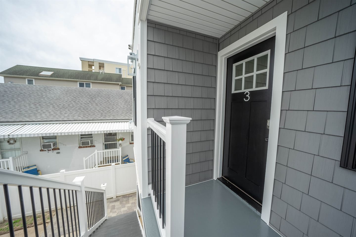 Private upper-level entry with covered landing and clear unit access. Elevated position offers a quiet arrival and added privacy, with easy stair access and a sheltered space to pause before heading inside.