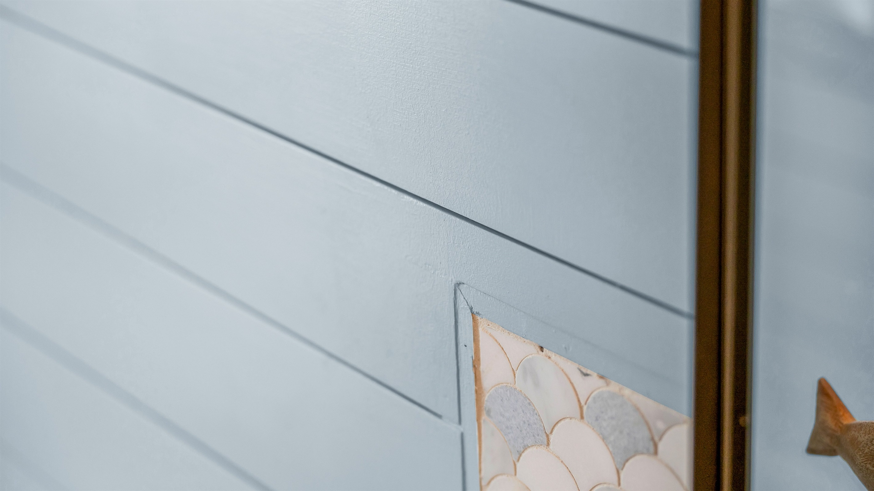 The second bathroom combines coastal charm with modern style, featuring blue shiplap walls, matt black fixtures, and a bright, airy design that brings a refreshing spa-like feel to the space