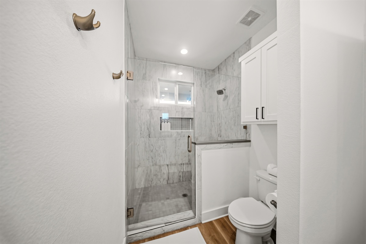 Modern upstairs primary bathroom serving king suite