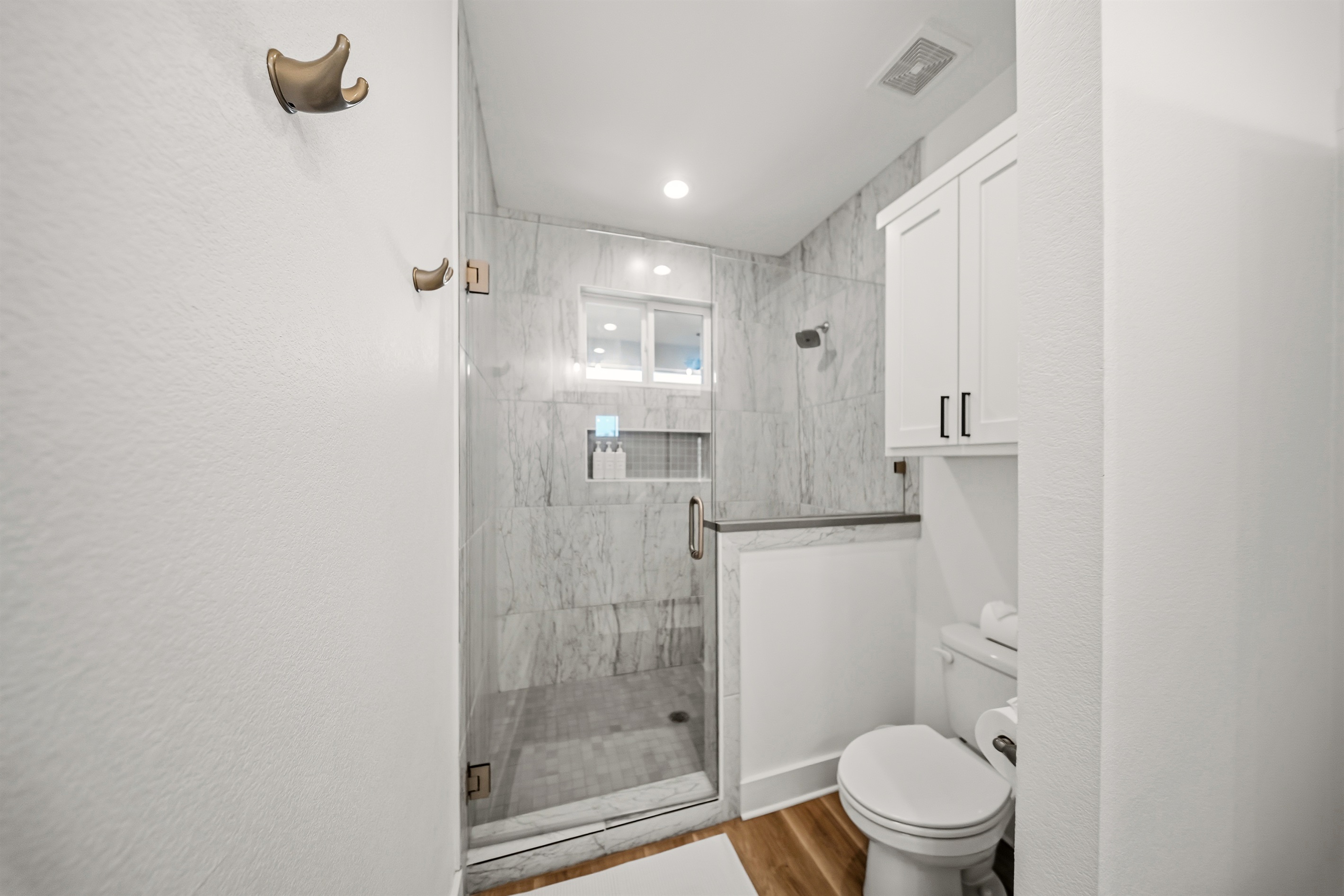 Modern upstairs primary bathroom serving king suite