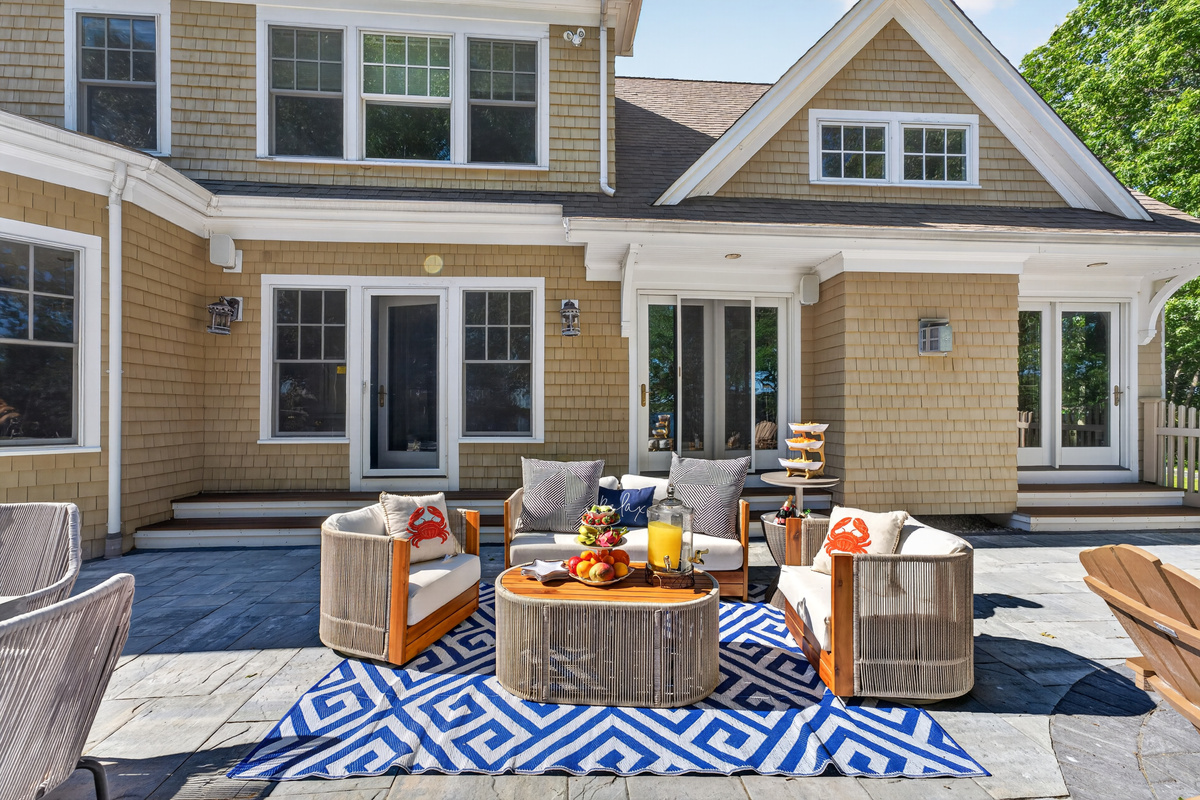 A full layout of lakeside living—grill, firepit, seating, and the water just steps away.