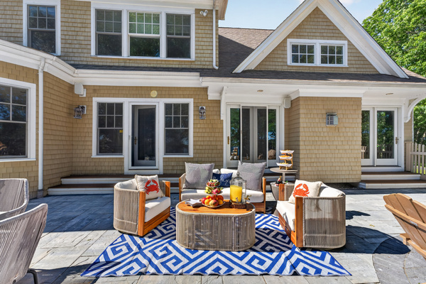 A full layout of lakeside living—grill, firepit, seating, and the water just steps away.