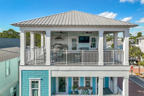 Rooftop patio featuring outdoor dining table, firepit, large sectional, and grill