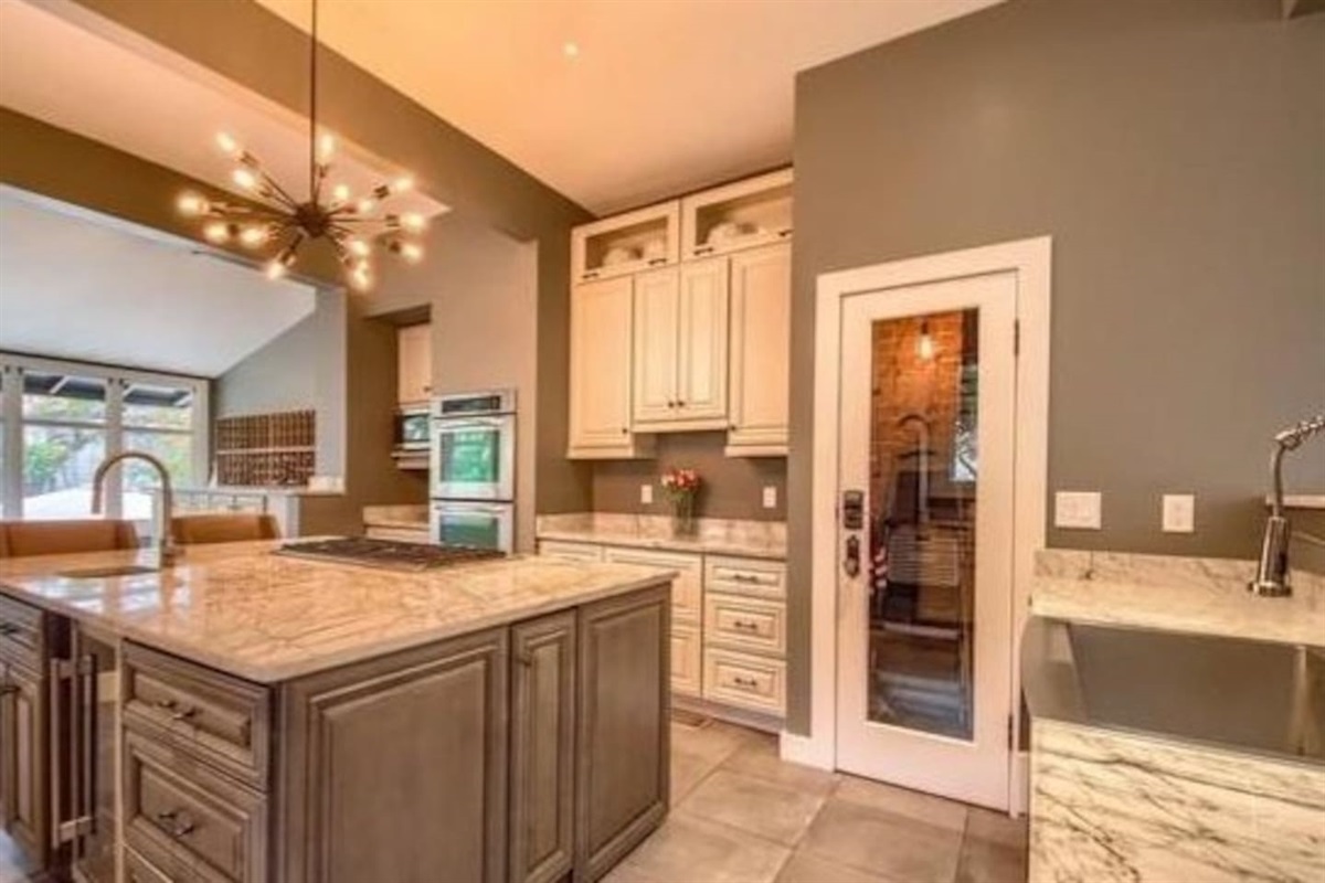  This historic yet modern home is beautiful inside and out. This kitchen is a cooks dream. 5 burner gas stove, prep sink in island, plenty space for you and all of your sous-chefs! Guest will not have access to the glass door pantry.