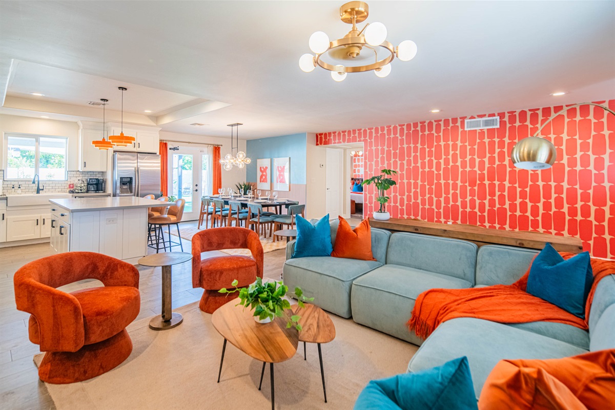 Inviting lounge area featuring modern décor, vibrant accent wall, and plush seating — a standout space for conversations, games, or casual downtime.