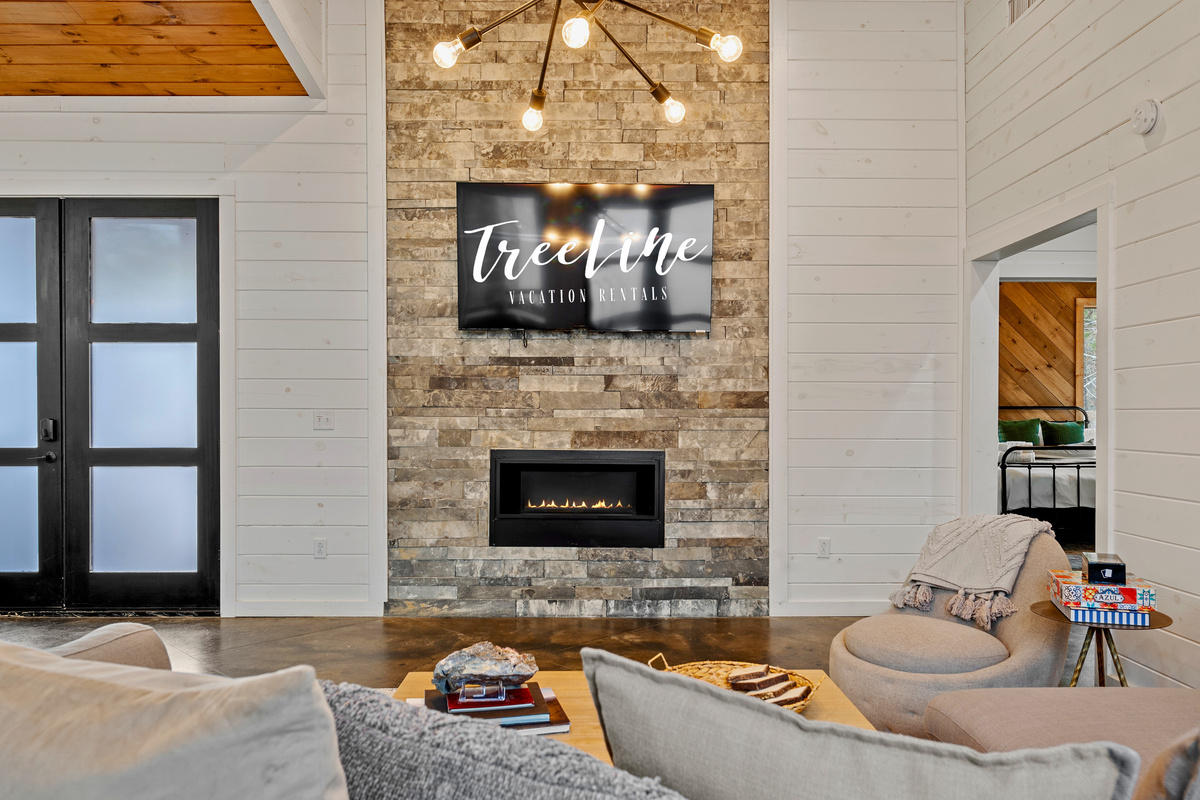 Settle in and let the good times roll! Our living room is the ultimate chill spot, with a warm fireplace and the perfect ambiance for making memories.
