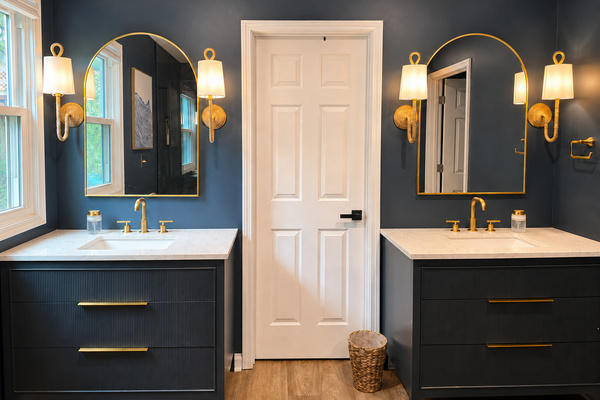 Spacious primary bathroom with dual vanities, warm lighting and plenty of room to get ready.