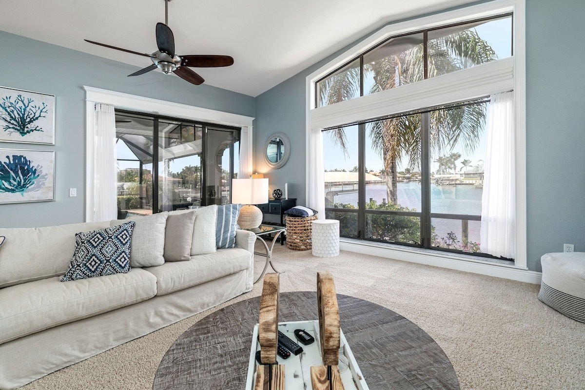 Floor-to-ceiling window frames a stunning water view
