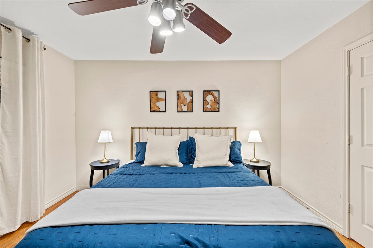 Drift into relaxation in this inviting king bedroom, complete with soft linens, warm lighting, and minimalist modern art.