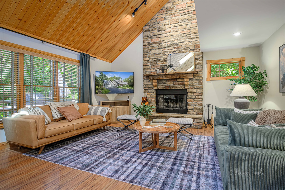 Living room with wood burning fireplace and Roku TV